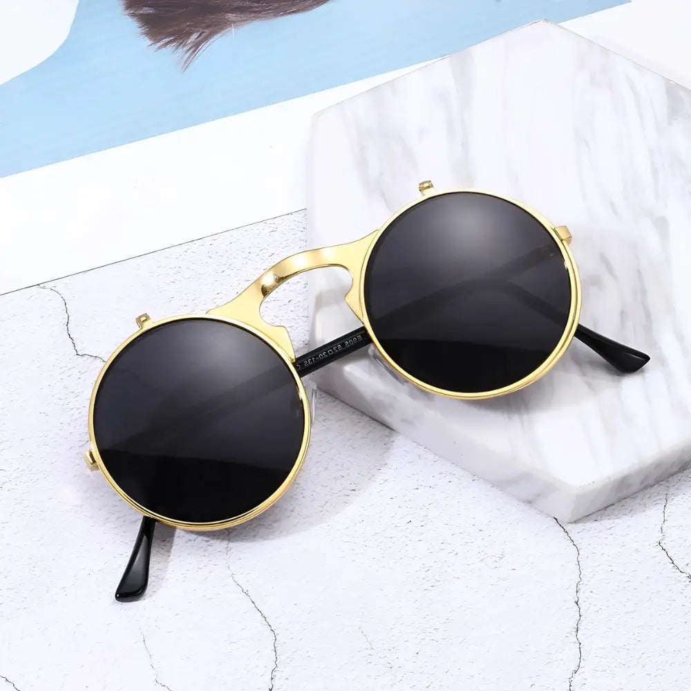 Occhiali da sole rotondi dorati neri